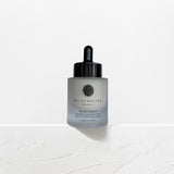 A bottle of Wild Pansy Advanced hydration serum against a white background, with a dropper dispenser.