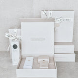 White product packaging with branded labels on a light gray background