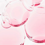Close-up of pink glass bowls on a white background