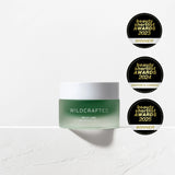 Green jar of Wildcrafted cream with multiple awards on a white background