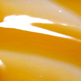 Close-up of a yellow and white object with a glossy finish