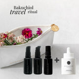 Bakuchiol travel ritual set with bottles and a dropper on a light background