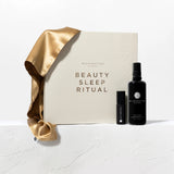 Beauty sleep ritual set with a gold satin sheet and Wildcrafted Organics products on a white background