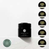 Black jar with 'Wildcrafted' branding and multiple awards on a light background